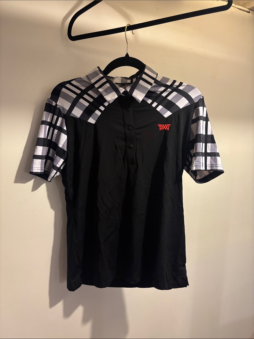 PXG Black Polo with White and Black Plaid Shoulders